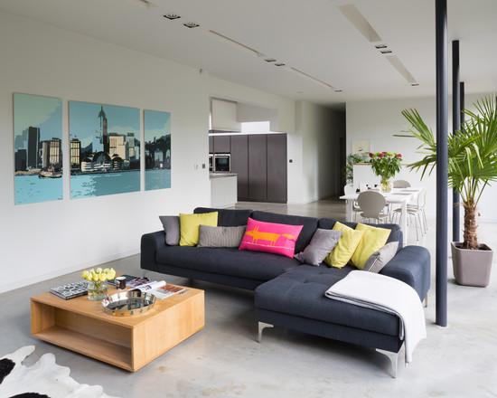 Black sofas with burnt cement floor make a perfect match