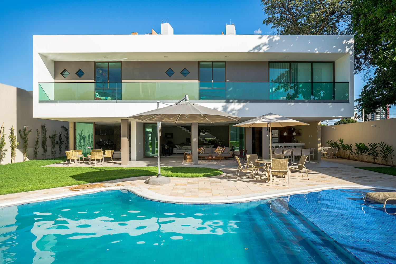 House model with glass railing and pool in the back