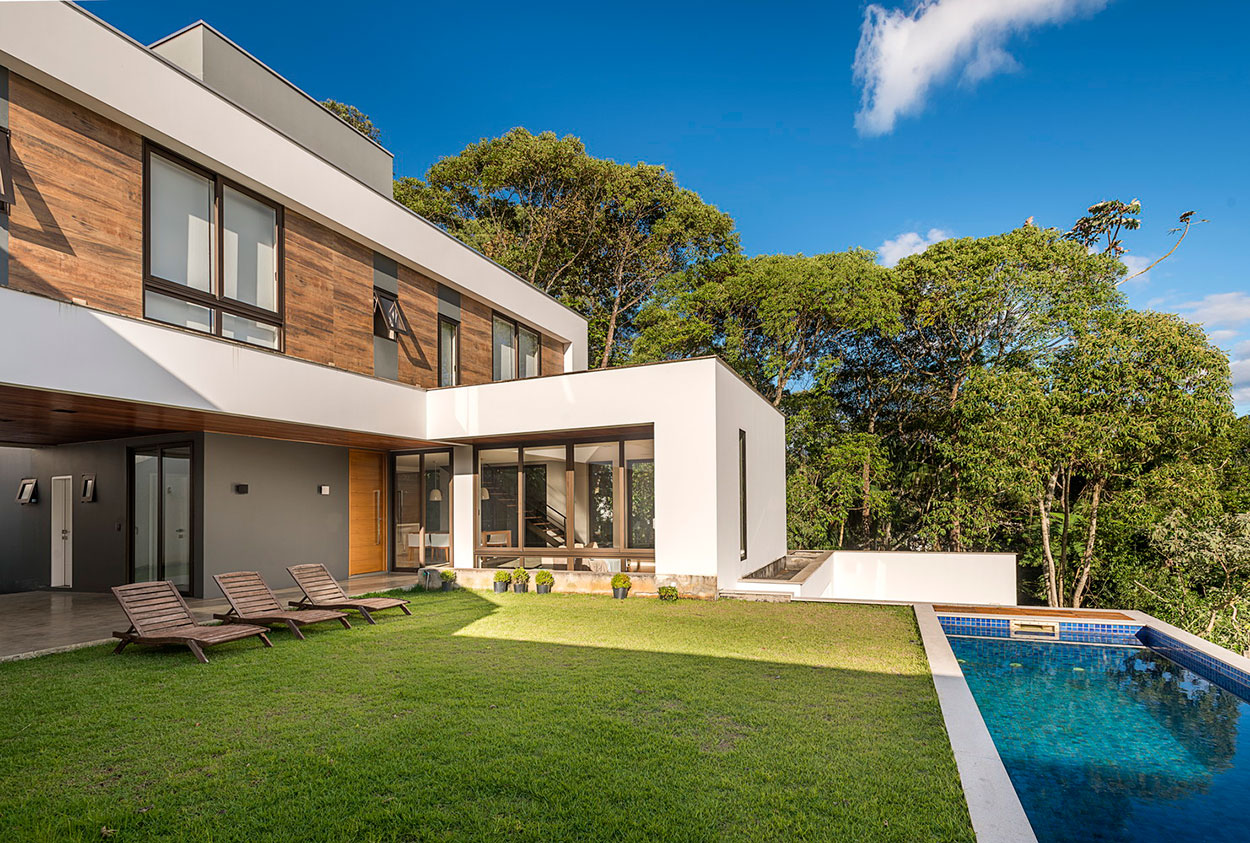 Back of a beautiful modern house with wood porcelain cladding on the upper floor