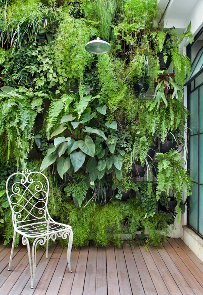 This vertical garden, built with pots attached to the wire mesh, is formed by a mix of half-shade plants.