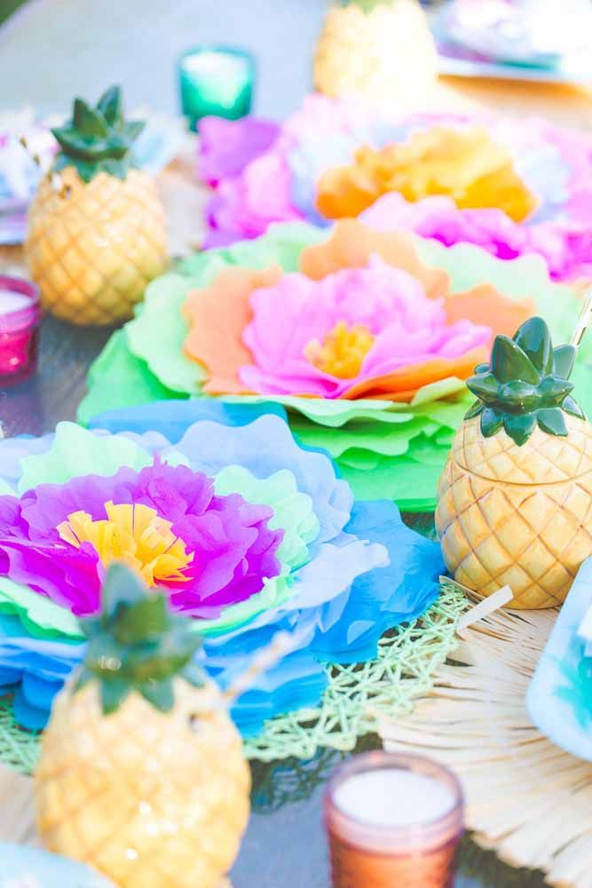Uma mesa colorida e tropical com flores de papel
