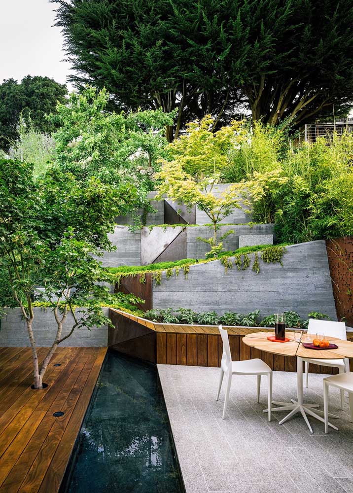 Os detalhes desse jardim moderno falam por si só; destaque para as formas geométricas nas paredes com muito verde