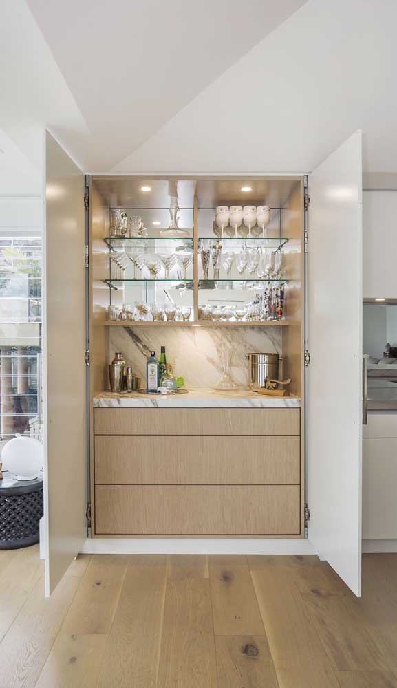 Super charming and elegant this home bar with wall-mounted glass shelves