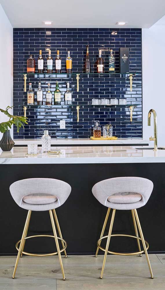 Here, the blue subway tiles add a special touch to the home bar