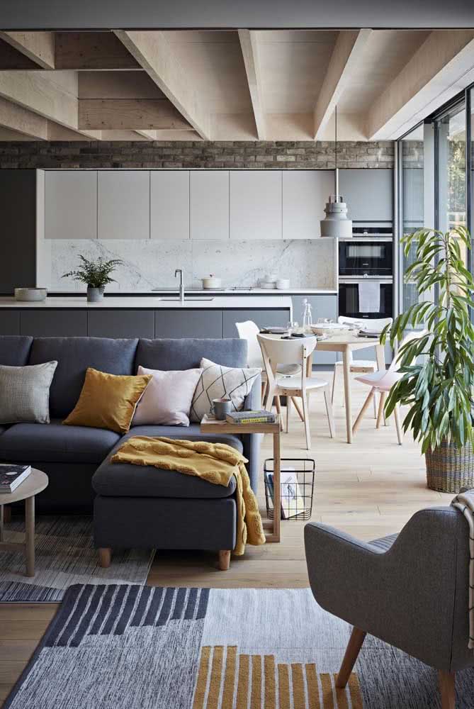 Cozinha conceito aberto com sala de estar e jantar. Os tons de cinza e azul circulam por todos os ambientes