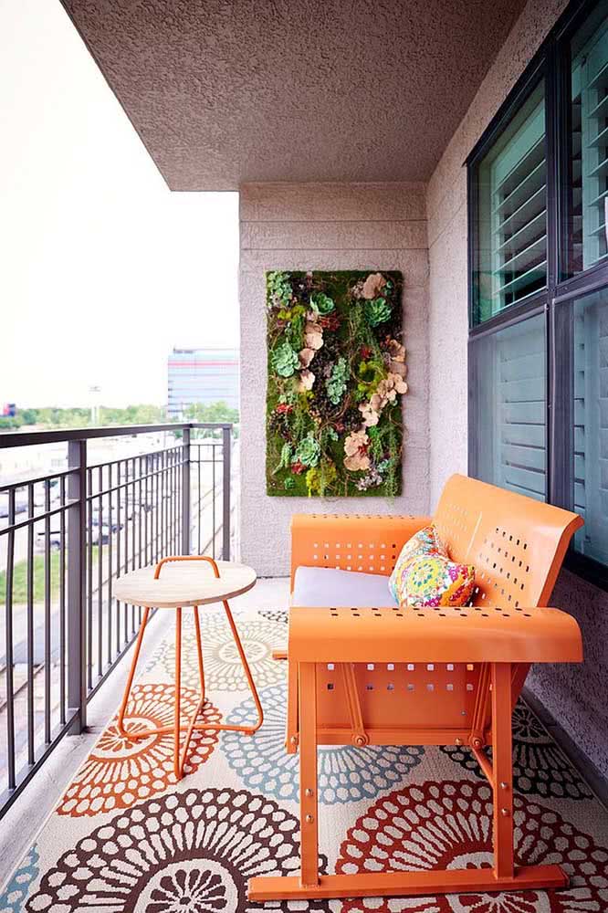 Decoração de varanda pequena com jardim vertical e cores quentes