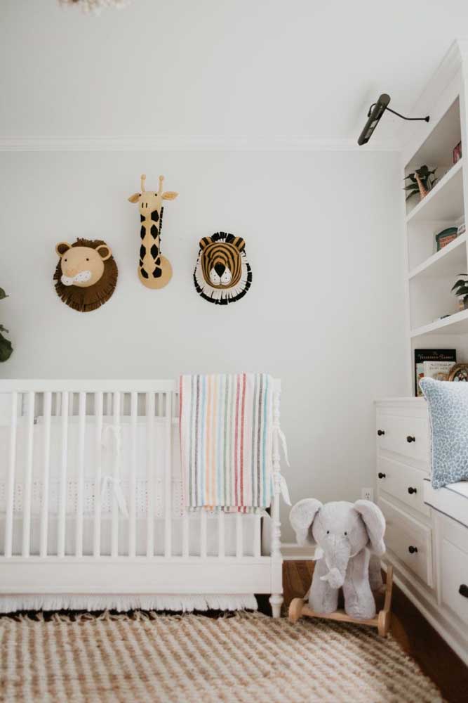 A parede branca ajuda a destacar os elementos do quarto de bebê safari simples