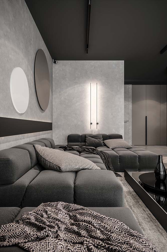 Sala super moderna com sofá de canto bem confortável de tecido cinza.