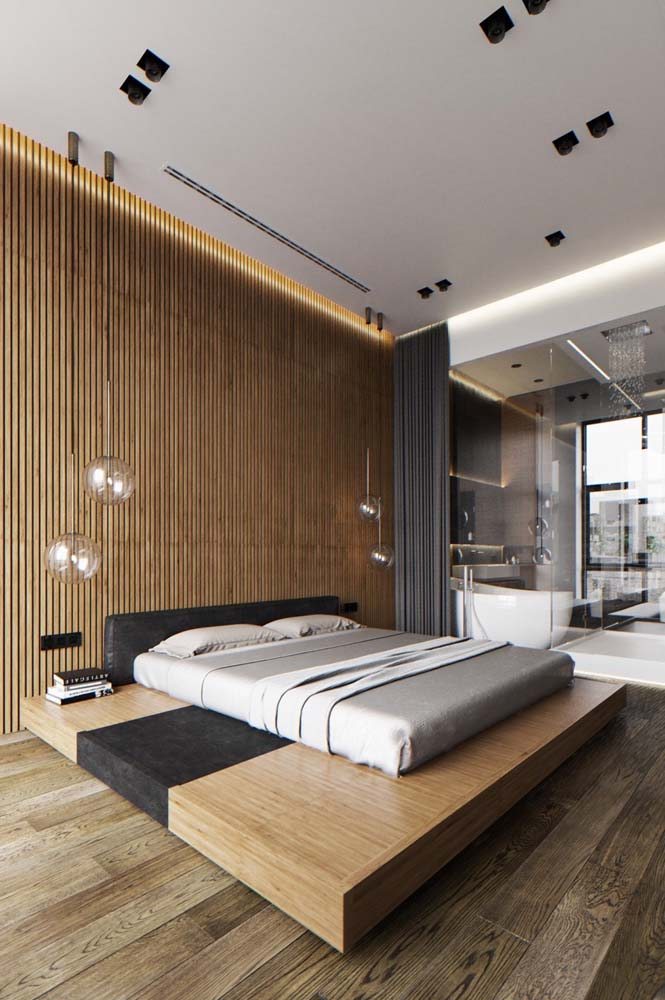 O modelo de cama japonesa é mais próximo ao piso, além de ser minimalista e simples. Neste ambiente há ainda a ampla presença da madeira: no piso, na base da cama e nas ripas da parede.